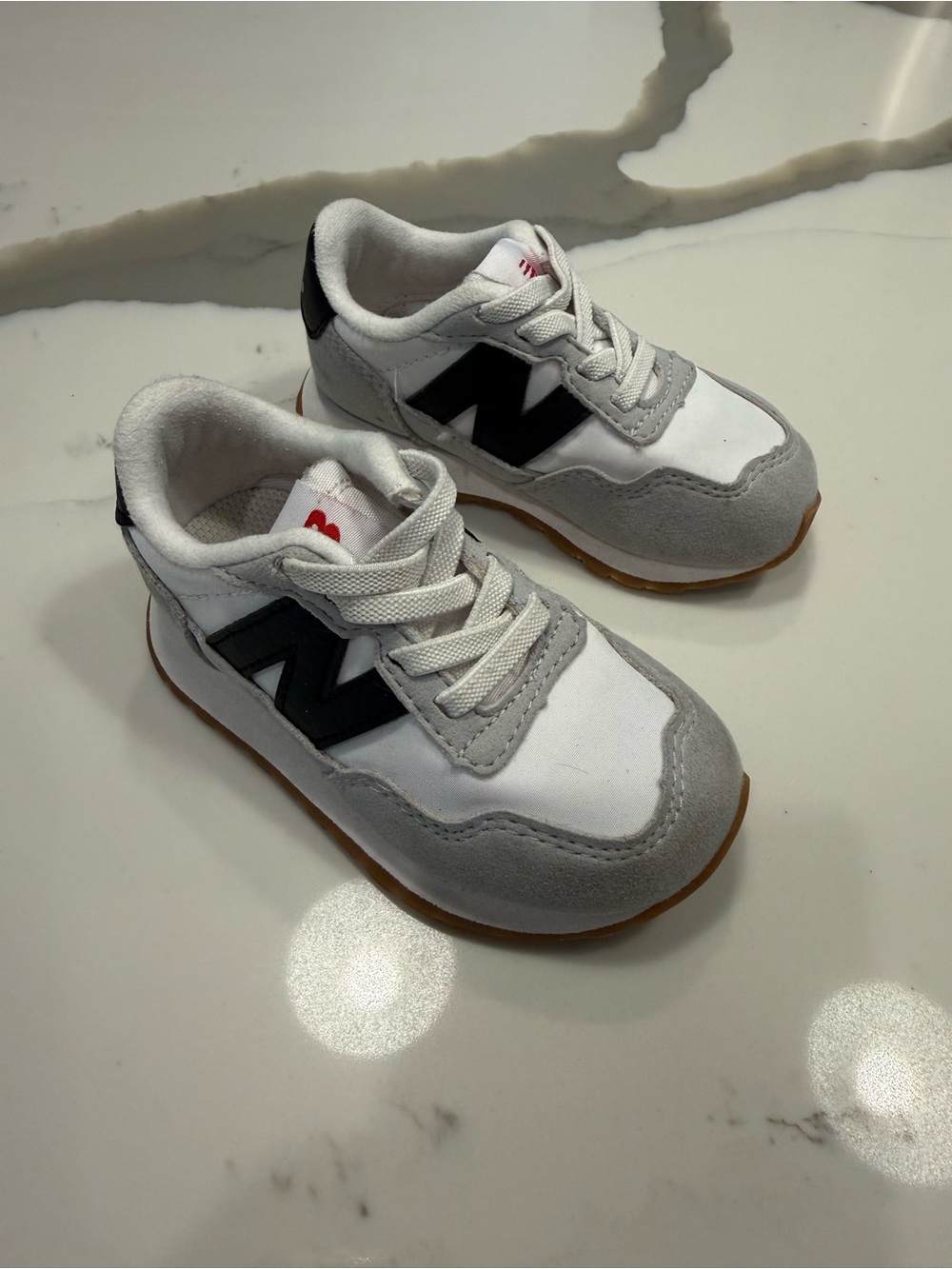 New Balance Kids Sneakers in White, Gray & Black